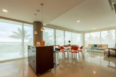 a kitchen and dining room with a table and chairs at Morros Vitri Beachfront & 2 Bedrooms in Cartagena de Indias