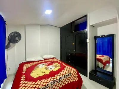a bedroom with a monkey blanket on a bed at Casa Tranquila in Cartagena de Indias