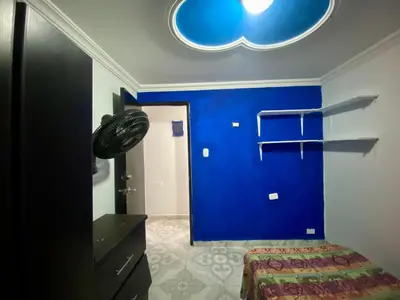 a room with a blue wall and a bed in it at Casa Tranquila in Cartagena de Indias