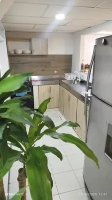 a kitchen with a refrigerator and a plant at Hermosa casa cerca de la playa in Cartagena de Indias