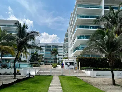 a man standing in front of a large building at Morros 922 Beach House in Cartagena de Indias