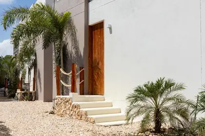 a white house with stairs and a cactus at Villa con piscina privada en coveñas sucre in Coveñas