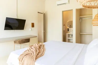a bedroom with a bed and a tv on a wall at Villa con piscina privada en coveñas sucre in Coveñas
