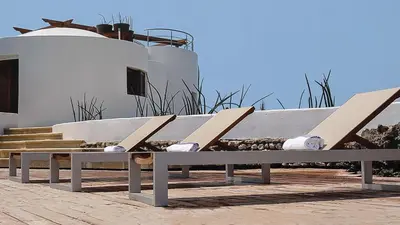 a bench sitting in front of a building at Isla Pelícano in Isla Grande