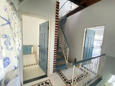 a stairway with a blue and white stair railing at Muy cerca del mar, areopuerto y centro histórico in Cartagena de Indias