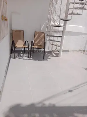 two chairs sitting on a floor next to a staircase at Casa Topacio in Cartagena de Indias