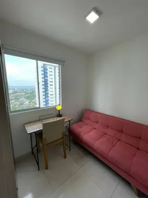 a red couch in a living room with a table at Ambiente Caribe! piso 26 - 3 hab in Cartagena de Indias