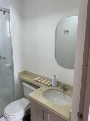 a bathroom with a sink and a toilet and a mirror at Ambiente Caribe! piso 26 - 3 hab in Cartagena de Indias