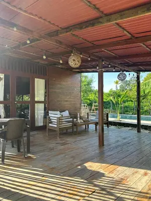 an outdoor patio with a wooden floor and a deck at Cabaña Privada con Piscina y Aire Acondicionado in Isla Fuerte
