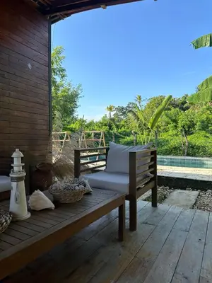 a wooden bench sitting on a wooden deck with a view at Cabaña Privada con Piscina y Aire Acondicionado in Isla Fuerte