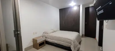 a small bedroom with a bed and a wooden cabinet at Excelente Apartamento Duplex in Sincelejo