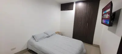 a small bedroom with a bed and a wooden cabinet at Excelente Apartamento Duplex in Sincelejo