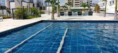 a swimming pool with blue water in a building at Apartamento en Pozos Colorados Santa Marta Suite 1309 -Pozos Colorados in Santa Marta