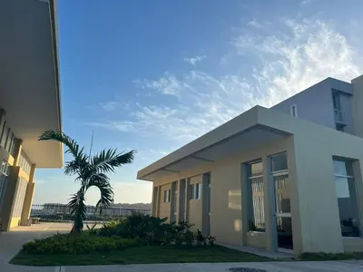 a building with a palm tree in front of it at Apartamento Amoblado en Cartagena in Cartagena de Indias