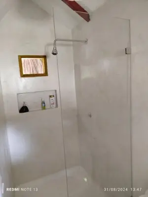 a shower with a glass door in a bathroom at Hotel Coral Sand Islas Del Rosario in Isla Grande