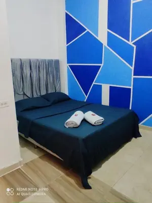 a bed with two slippers on top of it at Hotel Corales del Mar in Cartagena de Indias