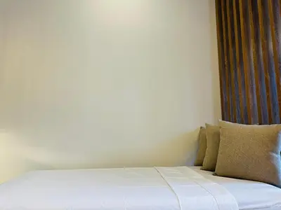 a bed with white sheets and pillows in a room at Exclusivo loft - frente al mar in Cartagena de Indias