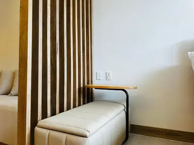 a room with a bed and a table and a stool at Exclusivo loft - frente al mar in Cartagena de Indias
