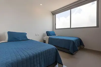 a bedroom with two beds and a window at Awesome Sea View and Historic Center “Morros City” in Cartagena de Indias