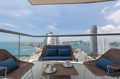 a balcony with chairs and a view of the ocean at Awesome Sea View and Historic Center “Morros City” in Cartagena de Indias