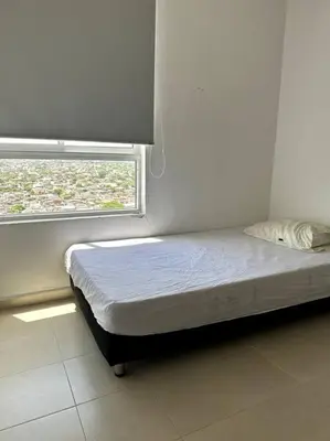 a small bed in a room with a window at Luminoso y confortable in Cartagena de Indias