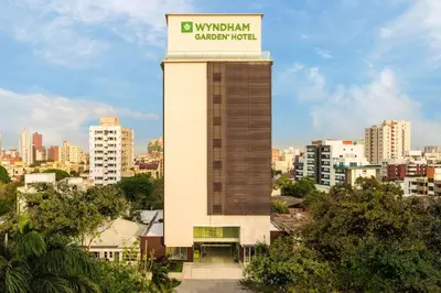 a building with a clock tower with a sign on it at Wyndham Garden Barranquilla in Barranquilla