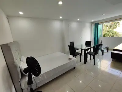 a living room with a couch and a table with chairs at EM3-1G APARTAMENTO DE 1 HAB EN ZONA RESIDENCIAL AIRE ACONDICIONADO Wifi Y PARQUEADERO in Cartagena de Indias