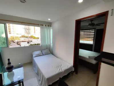 a small bedroom with a bed and a window at EM3-1G APARTAMENTO DE 1 HAB EN ZONA RESIDENCIAL AIRE ACONDICIONADO Wifi Y PARQUEADERO in Cartagena de Indias