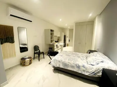 a bedroom with a bed and a desk in it at Espectacular apto Loft NUEVO- Frente al Hilton Pozos Colorados in Santa Marta