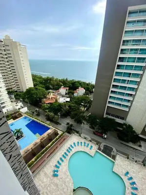 an aerial view of two pools in a city with buildings at Espectacular apto Loft NUEVO- Frente al Hilton Pozos Colorados in Santa Marta