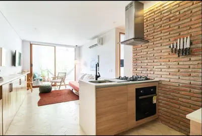 a kitchen with a stove and a brick wall at Cozy New Apartment in the Old City in Cartagena de Indias