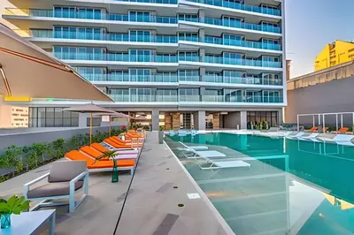 a swimming pool with lounge chairs and a building at Exclusive Sea View “Morros City” 30th Fl in Cartagena de Indias