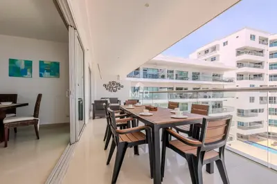a dining room with a table and chairs and a large window at Morros Epic - La Boquilla, Seaview & 2Bdr in Cartagena de Indias