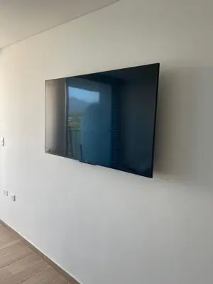 a flat screen tv hanging on a wall at Apartamento LOFT INFINITY BLUE in Santa Marta