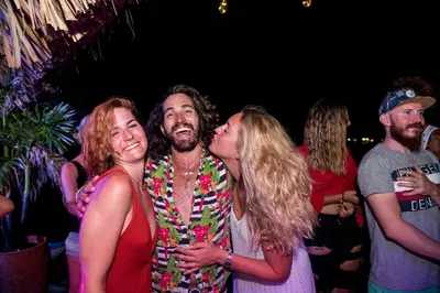 a group of people standing at a party at Casa en el agua in Tintipan Island