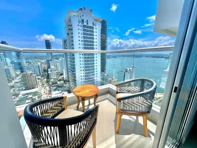 two chairs and a table on a balcony with a view at apto navy 6 tripulantes in Cartagena de Indias