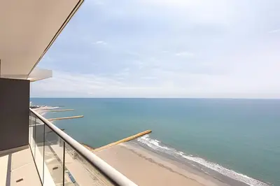 a view of the ocean from the balcony of a house at Vista al Mar y Centro Histórico “Morros City” 26fl in Cartagena de Indias