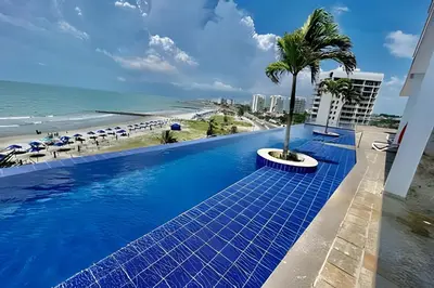 a swimming pool with a view of the beach at Piso 24 vista al mar 2BR in Cartagena de Indias