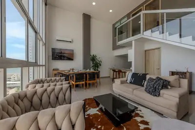 a living room with two couches and a table at Modern 3BR duplex Apt. Great view and location in Cartagena de Indias