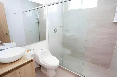 a bathroom with a shower and a toilet and a sink at Modern 3BR duplex Apt. Great view and location in Cartagena de Indias