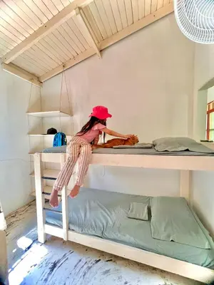 a woman sitting on top of a bunk bed at Cerca a Coveñas- Cabaña El Paraiso - Mar - Arena in San Antero