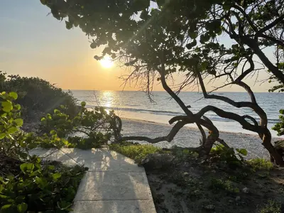 a pathway leading to the beach at sunset at La Felicidá in Cartagena de Indias