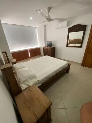 a bedroom with a bed and a ceiling fan at Cómodo y acogedor departamento in Cartagena de Indias