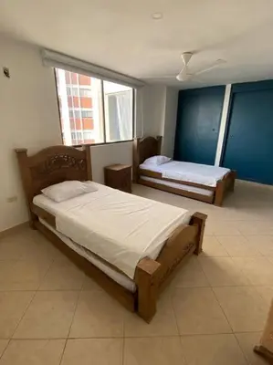 a bedroom with two beds in a room at Cómodo y acogedor departamento in Cartagena de Indias