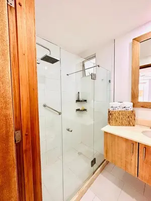 a bathroom with a glass shower and a sink at exclusivo edificio con piscina en primera linea de playa in Cartagena de Indias