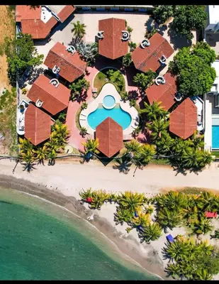 an aerial view of a resort with a swimming pool at Condominio Playa Caimán in Coveñitas