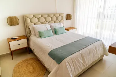 a bedroom with a large bed with two pillows at Exclusivo Apartamento en Baia Kristal 1 hab in Cartagena de Indias