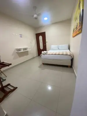 a bedroom with a bed in the corner of a room at Casa Hotel La Niña Neyla in Cartagena de Indias