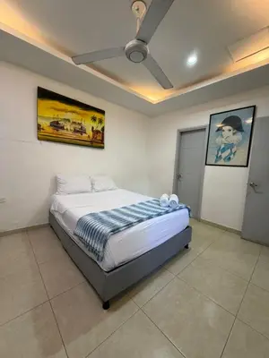 a bedroom with a bed with a ceiling fan at Casa Hotel La Niña Neyla in Cartagena de Indias