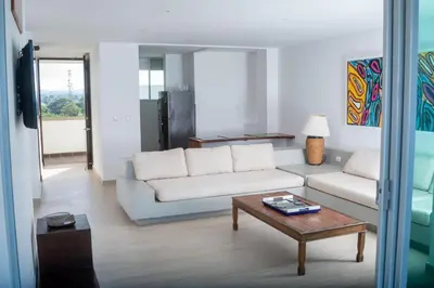 a living room with a white couch and a coffee table at Edificio Mares de Coveñas in Coveñas